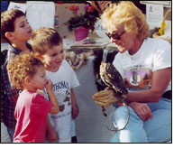 Ann Lynch shows an owl to kids
